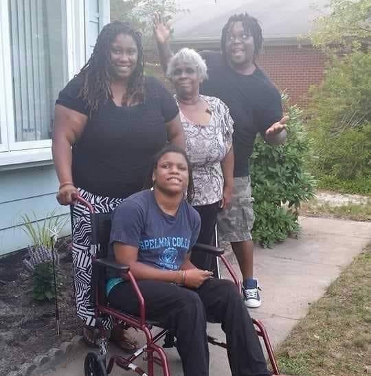 A picture of my sister, my grandma, my brother, and smiling at the camera in her backyard. 